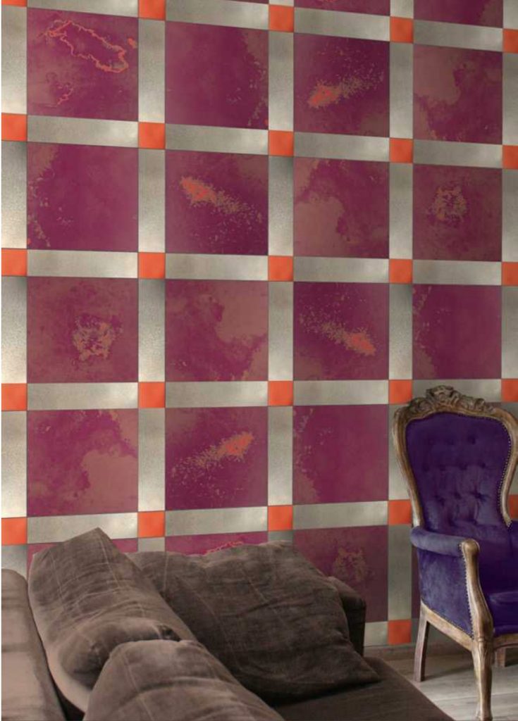 Unique mosaic with square shape in purple, orange and white set against a wall.