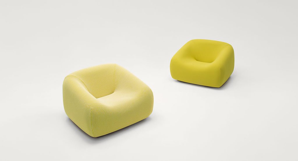 Two Smile Indoor Armchairs, upholstery in yellow fabric on a white background.