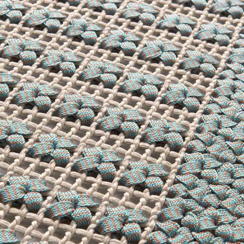 Siepe rug, embroidery made of flat braid in kimia blue and brown fabric.