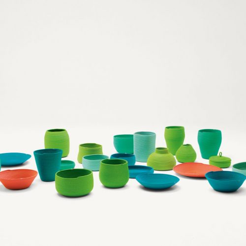 Sika baskets, vases, bowls and planter covers with different form and dimension made with a Rope cord, nine in blue, twelve in green, two in orange on a white background.