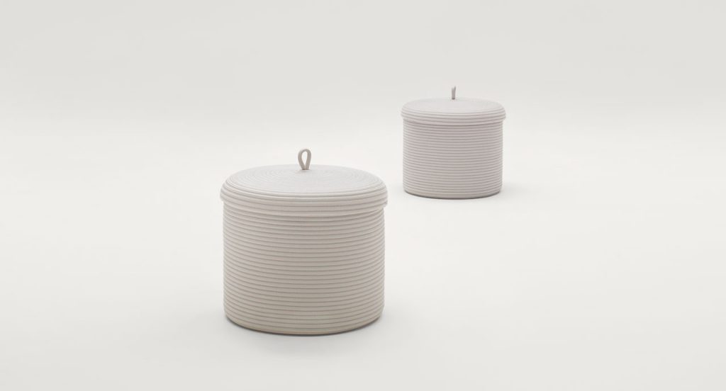 Two white Sika vases with top on a white background.
