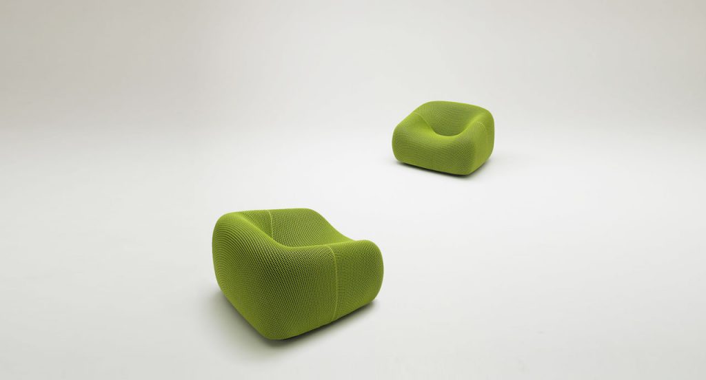 Two Smile Outdoor Armchairs, upholstered in green aero fabric on a white background.