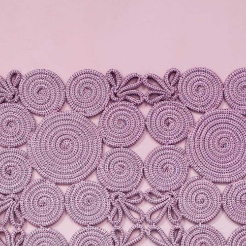 Spin Modular Rug made of purple sewn spirals and leaves on a purple background.