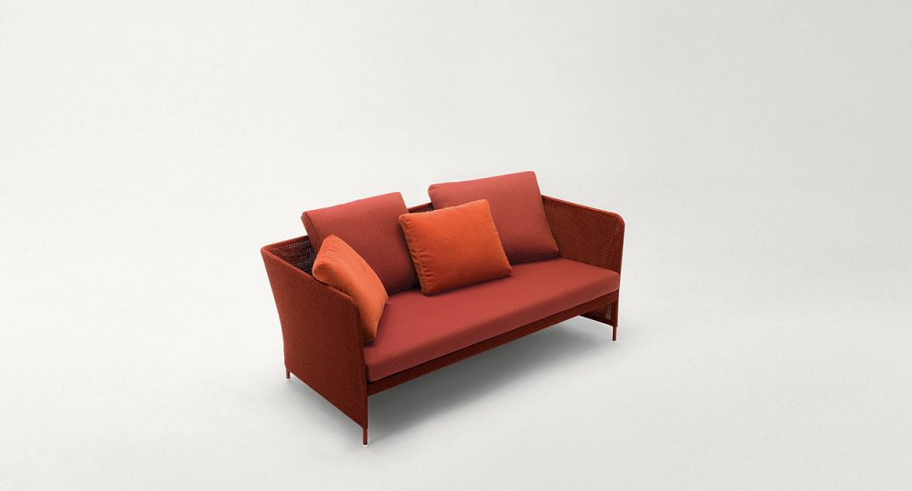 Red Teatime Sofa with armrest. Upholstery of braids in rope on a white background.