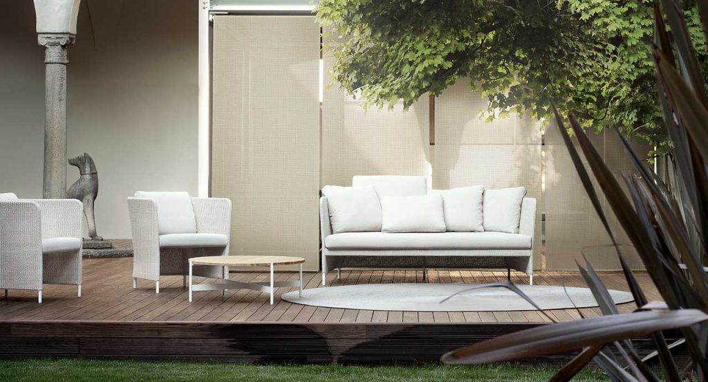 Brown and white Teatime Sofa with armrest. Upholstery of braids in rope in an outdoor space.