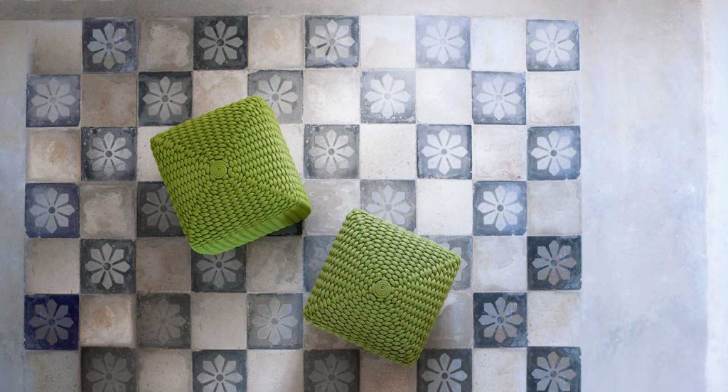 Two green Tide poufs, upholstery woven with Rope cord in a blue and white floor.