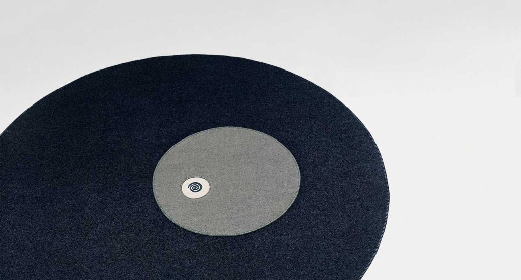 Round Tondo rug in black with three grey and white central circles on a white background.