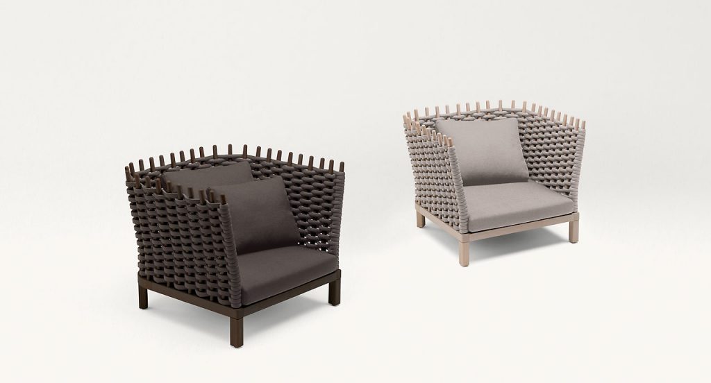 Two Wavi armchairs, structural weave and seat cushions, one in grey and one in brown; and structural wood one in natural color and one in brown on a white background.