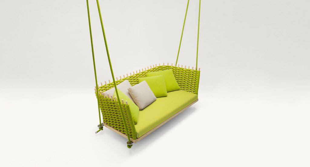 Green lawn swing covered with rope yarn, cushion upholstery on a white background.