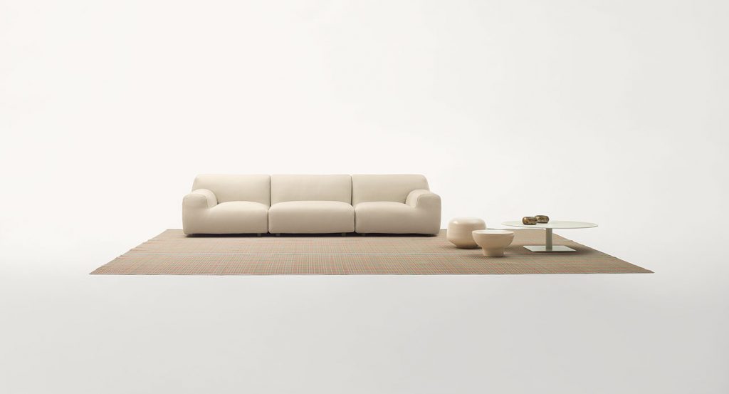 White Welcome modular seating system with armrest backrest, three seats, in a living room.