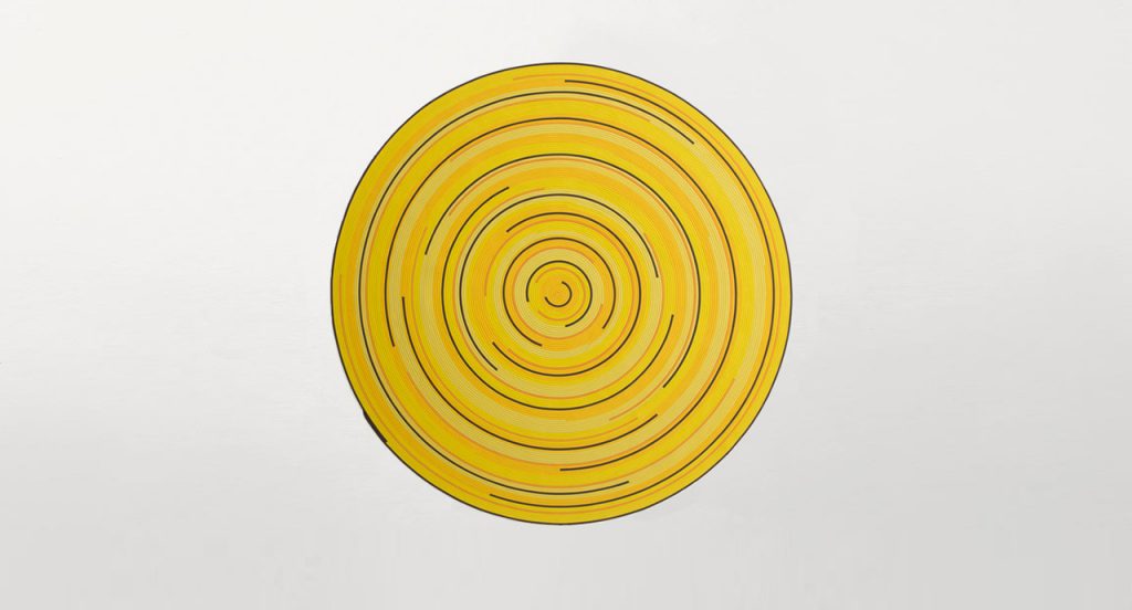 Zoe Rev rug in yellow, orange and brown cords in a spiral-like pattern on a white background.