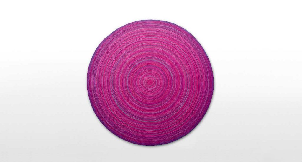Zoe Natural rug wool cord spiral module in pink and purple on a white background.