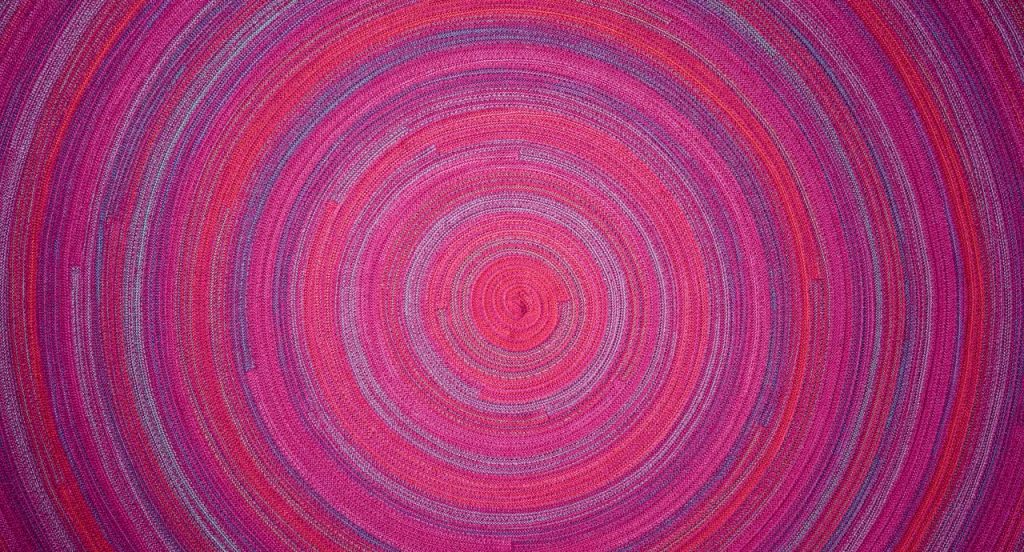 Zoe Natural rug wool cord spiral module in pink and purple.