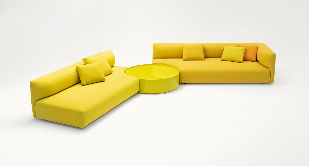 Two yellow Walt Sofas of three seats with high back on a white background.