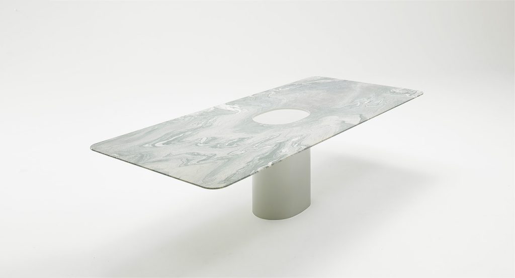 Taol large dining table, base in steel, rectangular top in white marmol on a white background.