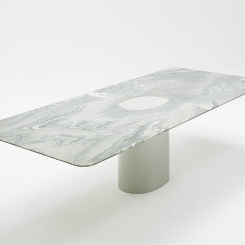 Taol large dining table, base in steel, rectangular top in white marmol on a white background.