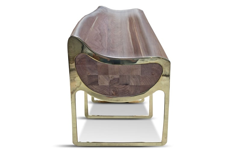 bench made of four gilt steel legs and brown carved wood tops on a white background