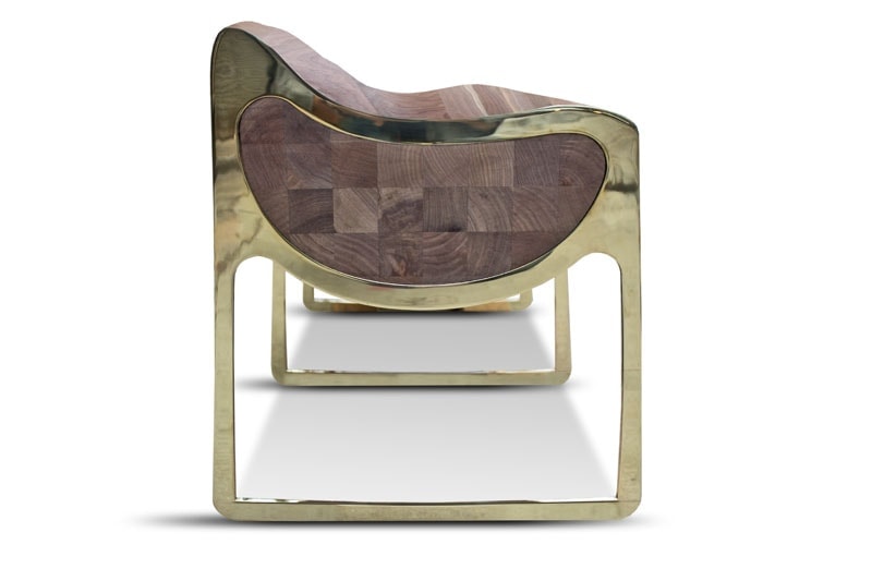 bench made of four gilt steel legs and brown carved wood tops on a white background