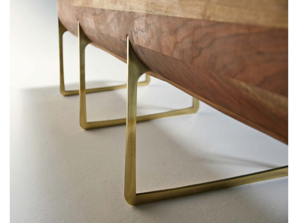 bench finish made of gilded steel and lacquered carved wood on a white background