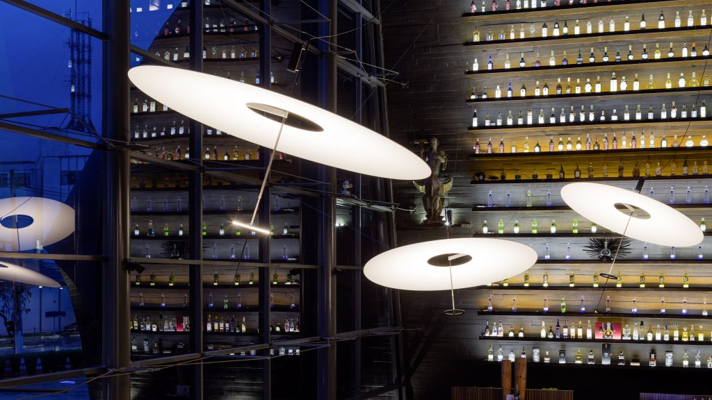 A room with three Flying Disc lights in front of a window