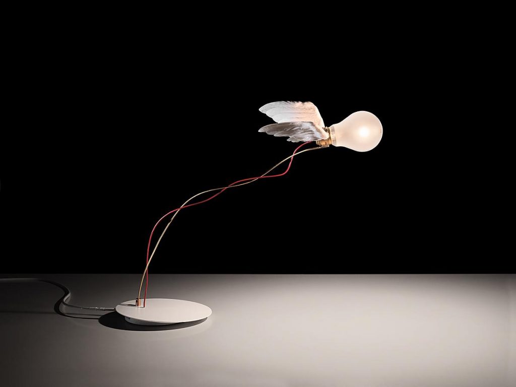 A Lucellino Table light on a white table with a black background
