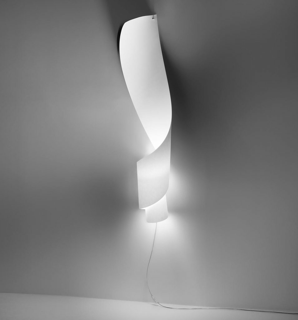 Oop's light in white on a grey wall illuminated