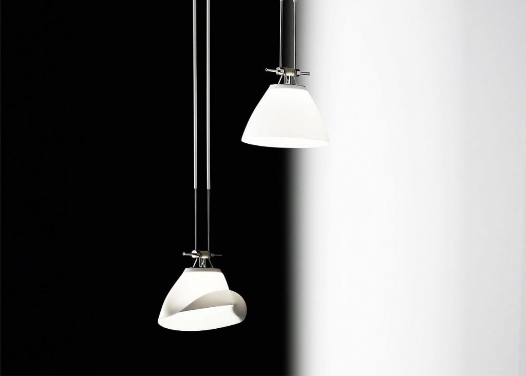 A couple of Yayaho Element fourteen lights hanging from a ceiling in front of a white and black background