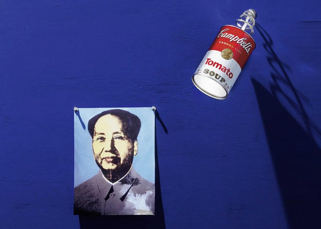 A picture of a person on a blue wall next to a Canned Light