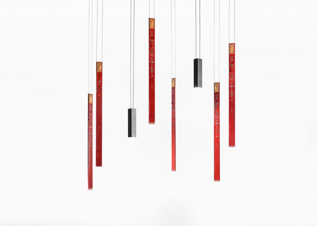 A group of red and black Flying Flames hanging from a ceiling in front of a white background