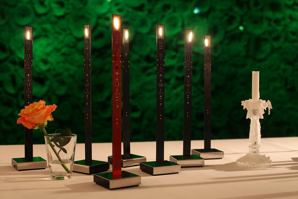 A group of My New Flame candles in red and black colors sitting on top of a table