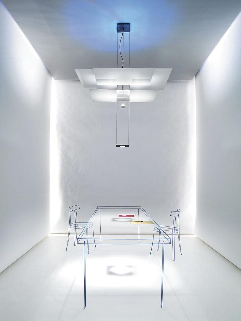 A Oh Mei Ma light hanging over a table and chairs in a white room