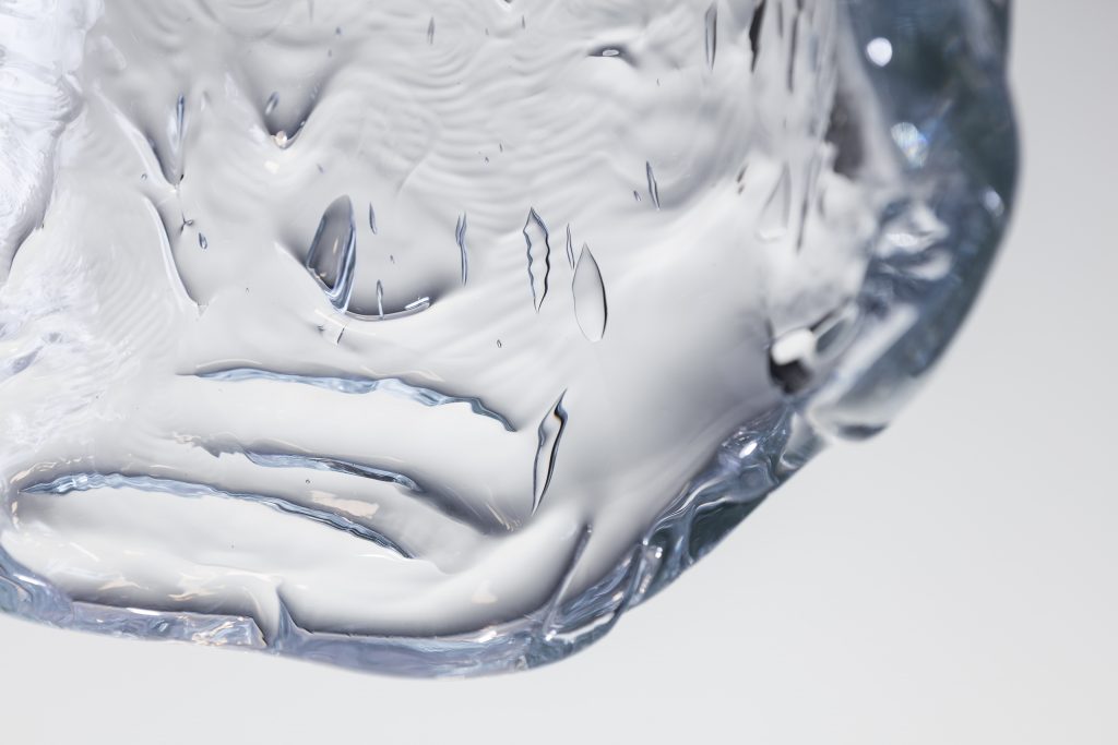 small ceiling lamp made of blown glass in the shape of a drop of water on a white background