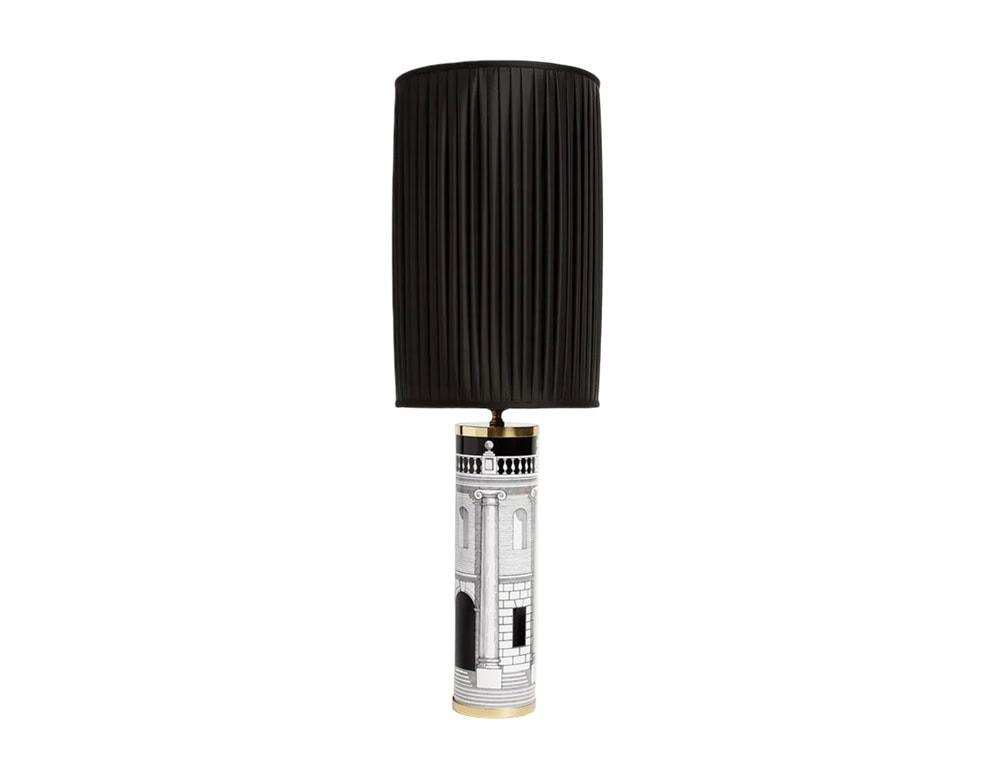 Tall cylindrical table lamp featuring a black pleated shade and a finely detailed base with classical architectural design, adding bold contrast to any room.