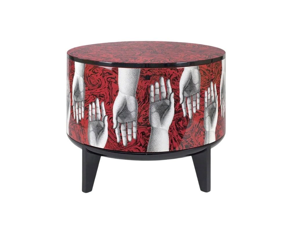A striking round side table featuring bold red tones and intricate hand illustrations, blending art and function to create a captivating statement piece.