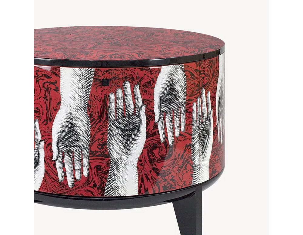 Distinctive side table with rich red patterns and detailed hand artwork, accented by a smooth wood panel for an artistic yet practical touch.