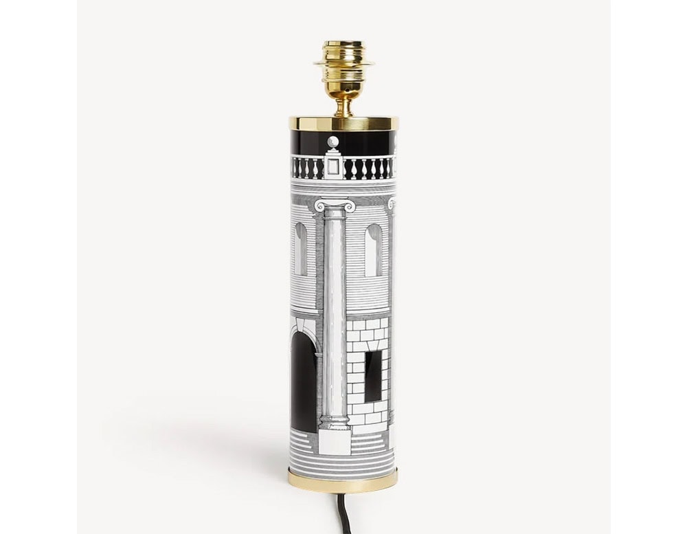 Cylindrical lamp base with intricate architectural artwork in contrasting tones and refined gold finishes, offering a timeless and elegant base for a custom shade.