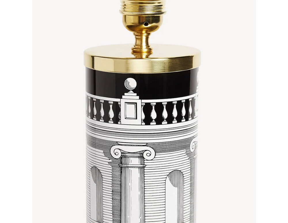 Lamp base featuring a cylindrical form with striking black and white architectural details and gold accents, creating a bold and sophisticated foundation for lighting.