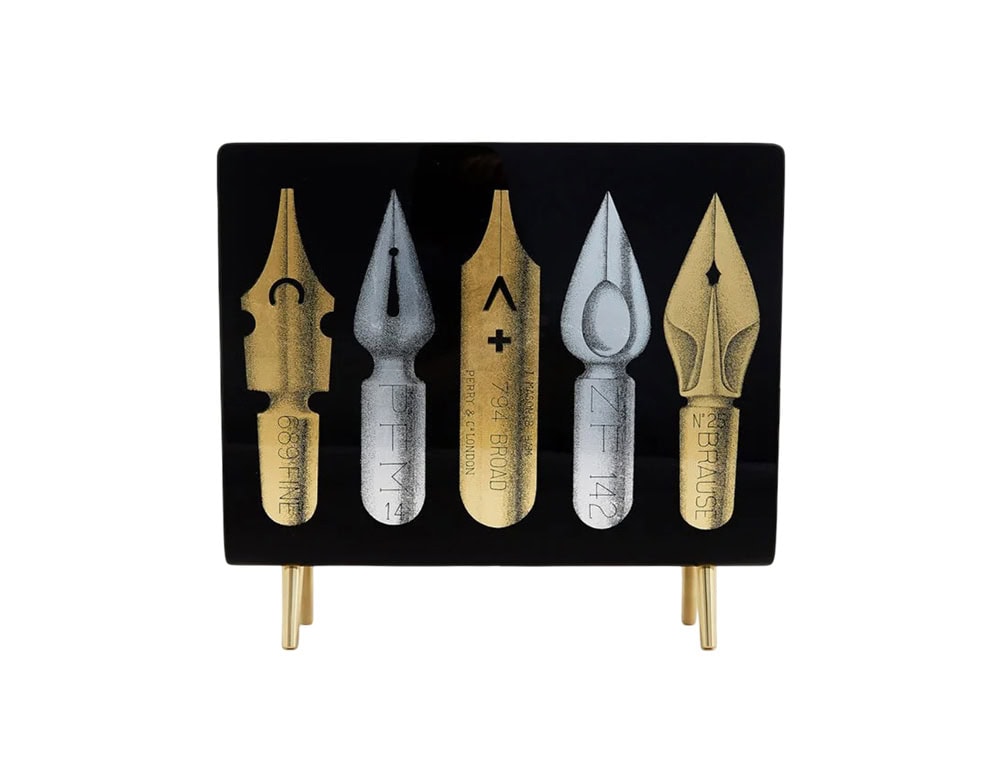 This magazine rack combines mid-century charm with a graphic Fornasetti design, transforming everyday organization into a captivating conversation piece.