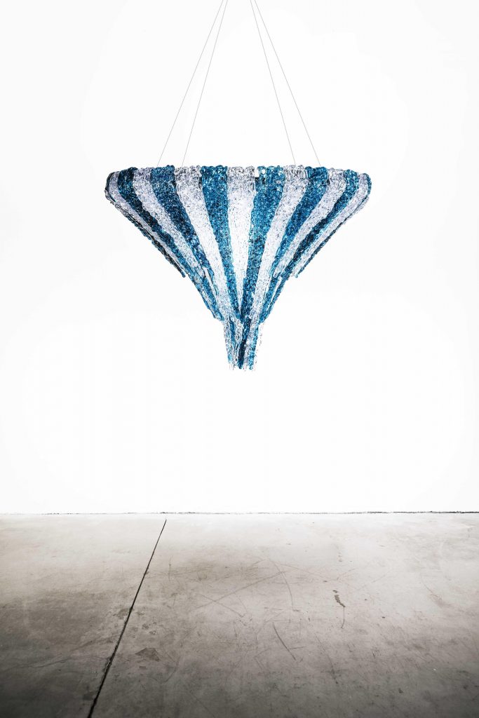 thick and colorful threads of methacrylic glass in the shape of an upside-down pyramid in a white and dark blue color tone