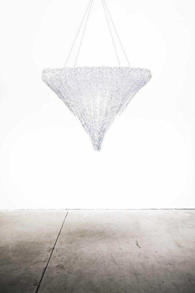thick and colorful threads of methacrylic glass in the shape of an upside-down pyramid in a white color tone