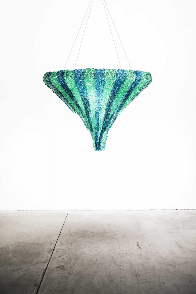 thick and colorful threads of methacrylic glass in the shape of an upside-down pyramid in a light blue and green color tone