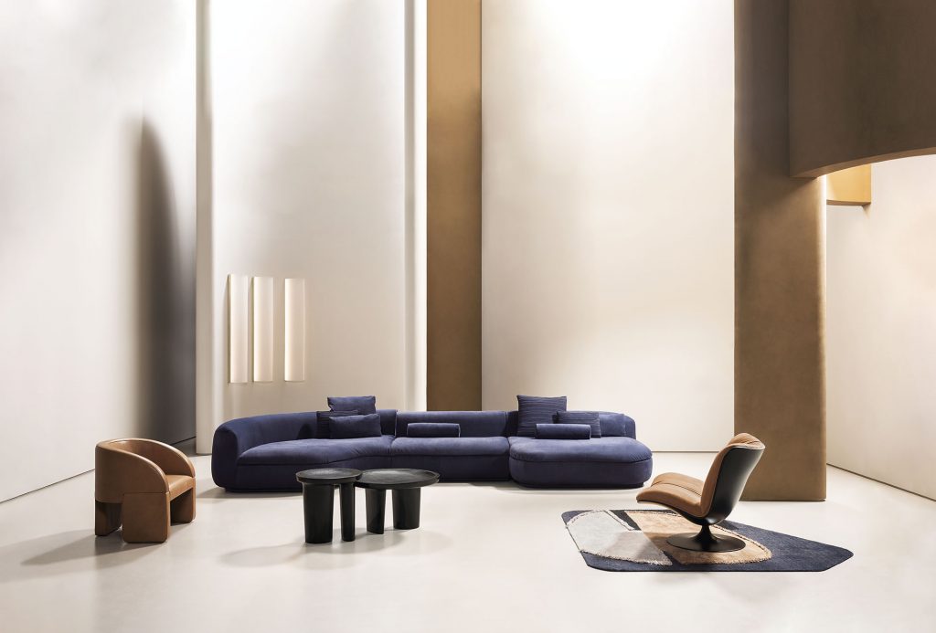 large sectional sofa made of velvet fabric in a purple tone in a living room