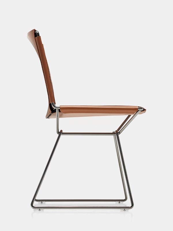 chair made of steel finished in black chrome and leather seat in a orange tone on a white background