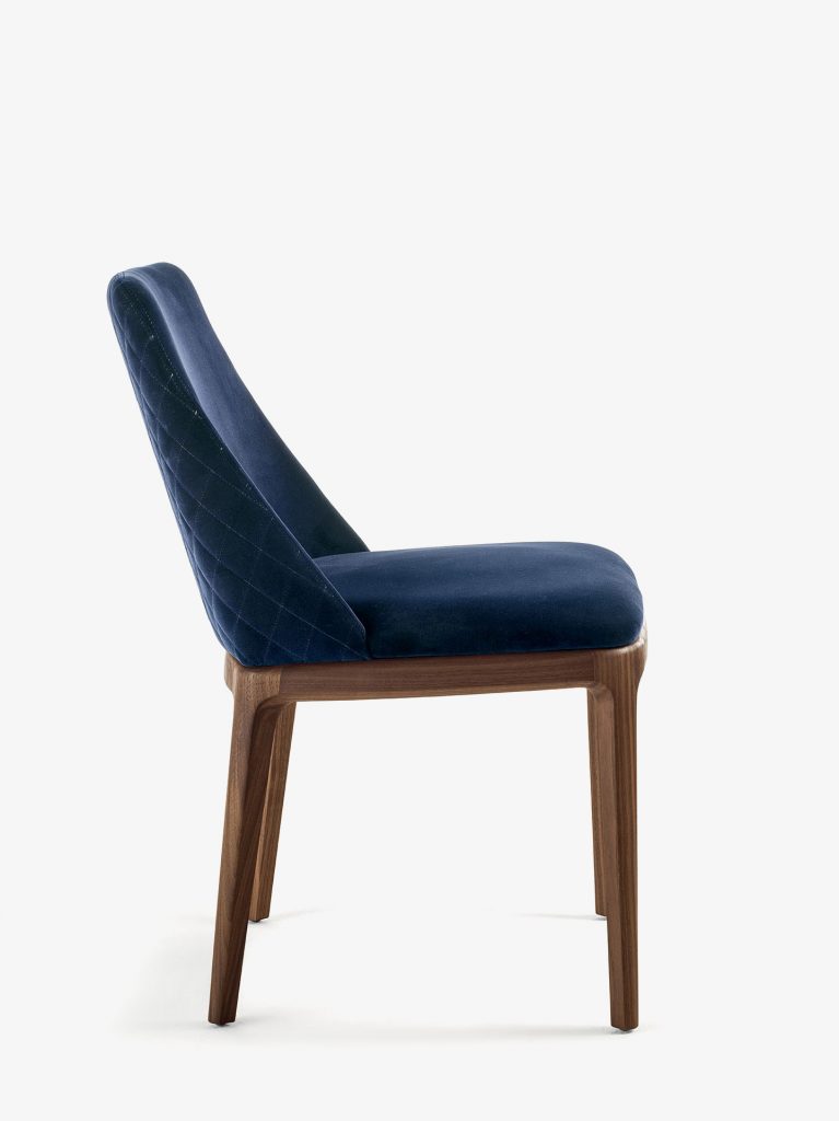 chair made of smooth fabric in a dark blue tone resting on solid brown wooden legs