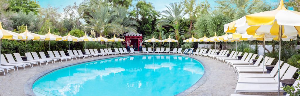 line of parasols in a peaked shape made of metal and fabric base in a white and yellow color tone