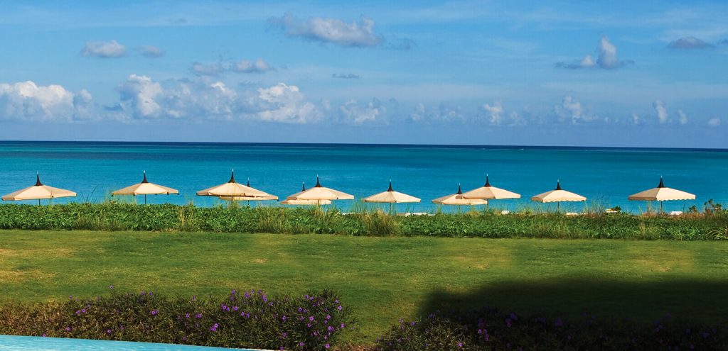 line of parasols in a peaked shape made of metal and fabric base in a white and yellow color tone in the a beach