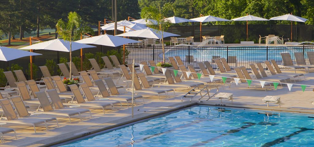 line of umbrellas with low base made of wood and fabric in shades of brown and white