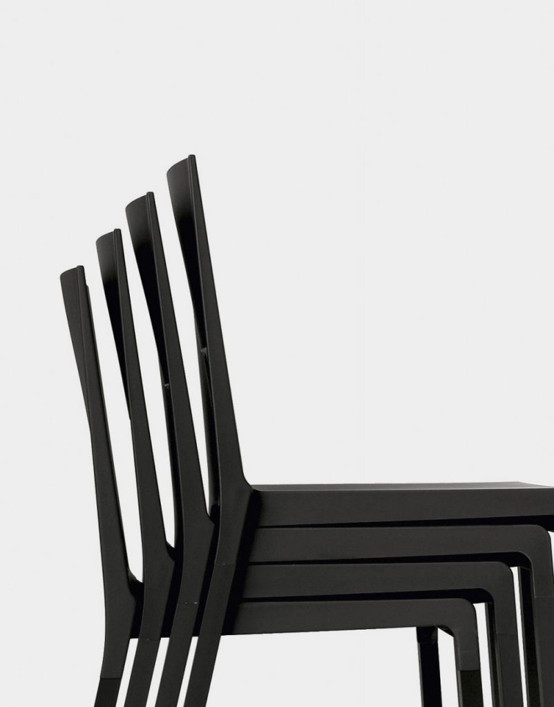 four chairs one on top of the other made of polyurethane base in shades of black on a white background