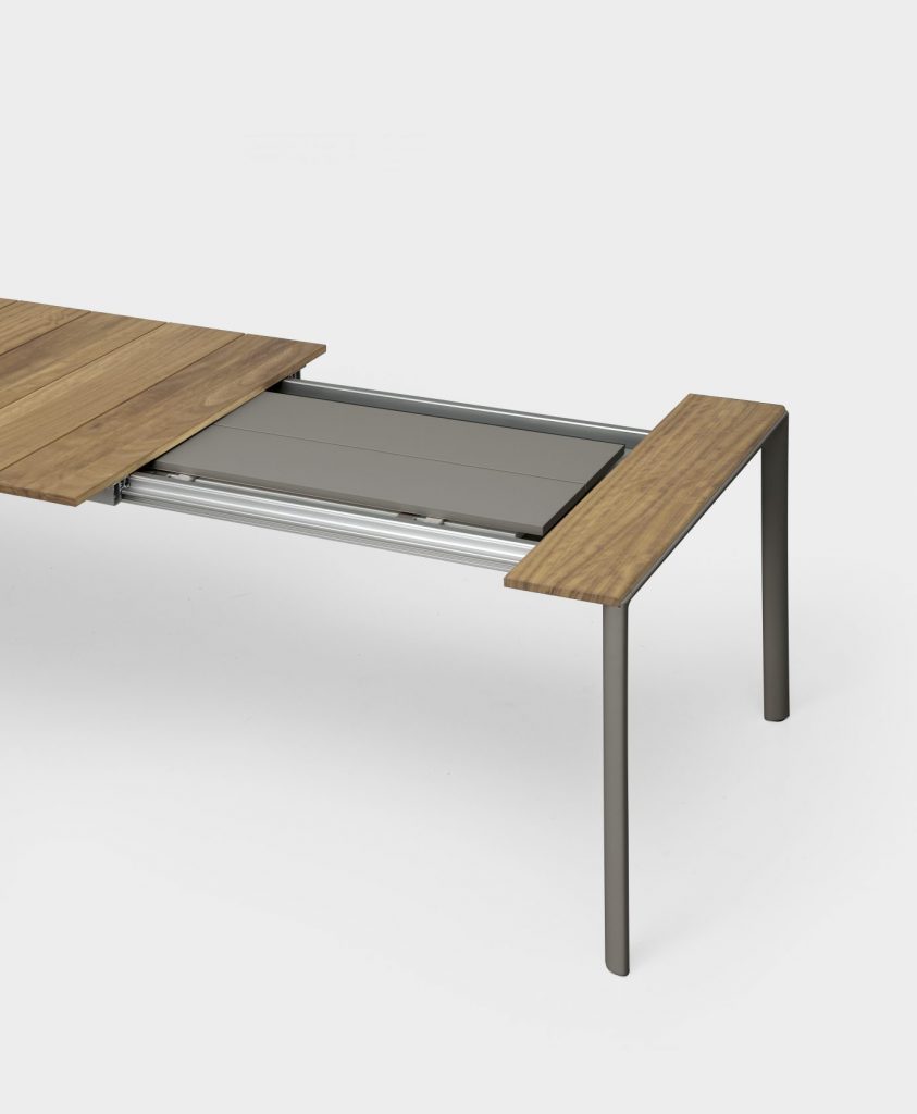 extendable table made of metal and aluminum in a gray tone with coffee on a white background