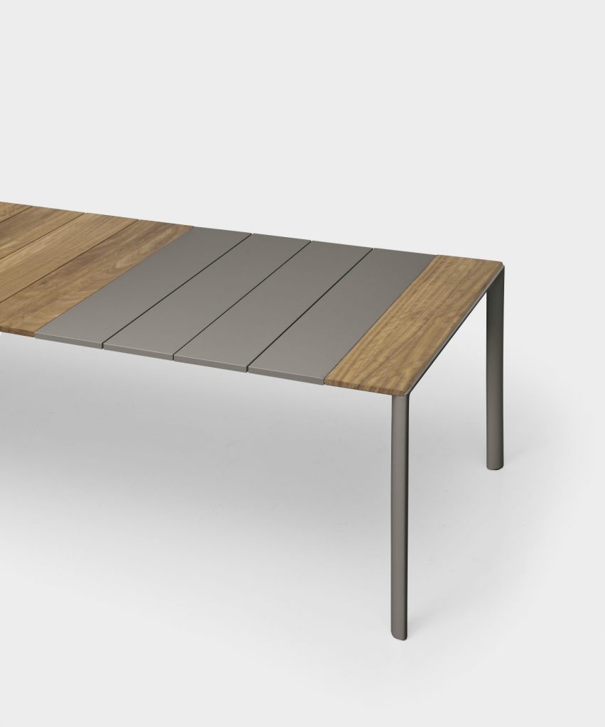 Rectangular-shaped table made with a base of metal legs and aluminum top in a gray and coffe tone